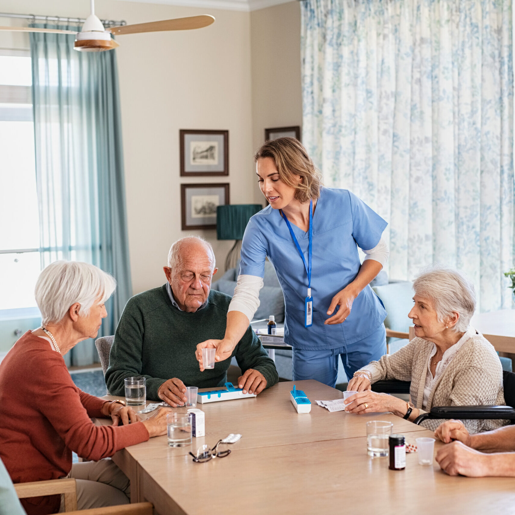 caregiver-giving-medicine-to-group-of-senior-men-a-2025-10-10-18-41-52-utc